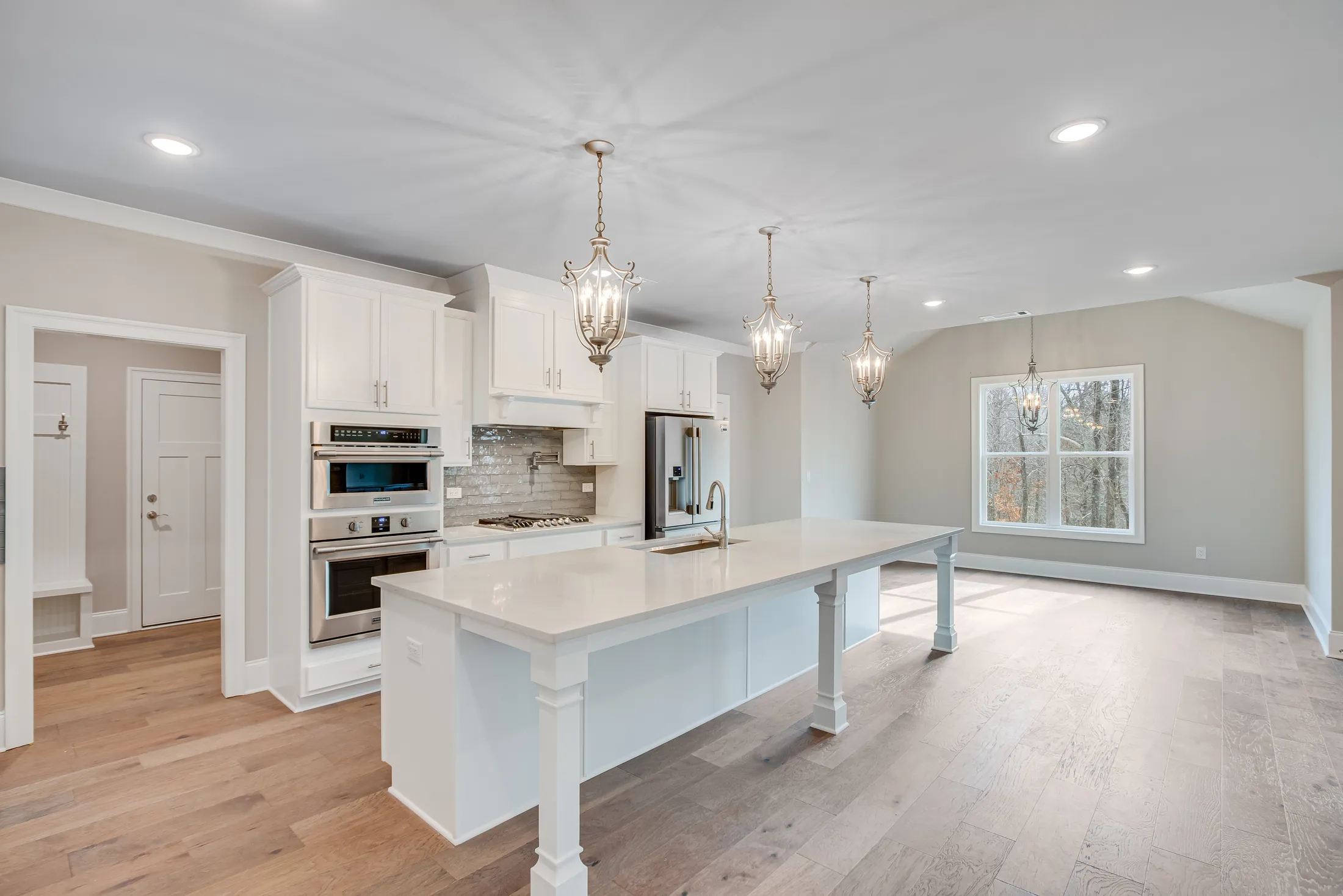 Open kitchen with a long island and three pendant lights