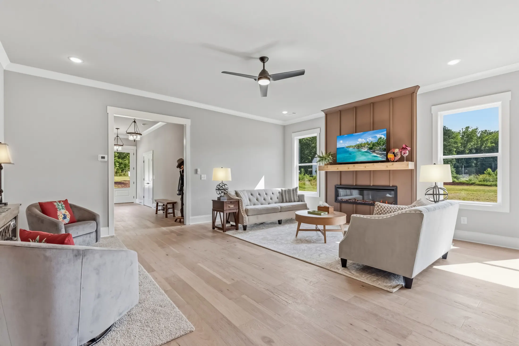 Living room with a board-and-batten fireplace wall and a view down the entry hall